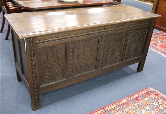 An oak coffer, with carved panelled front W.143cm